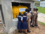 Carribean school children crowding around a LifeSaver C2 water purifier